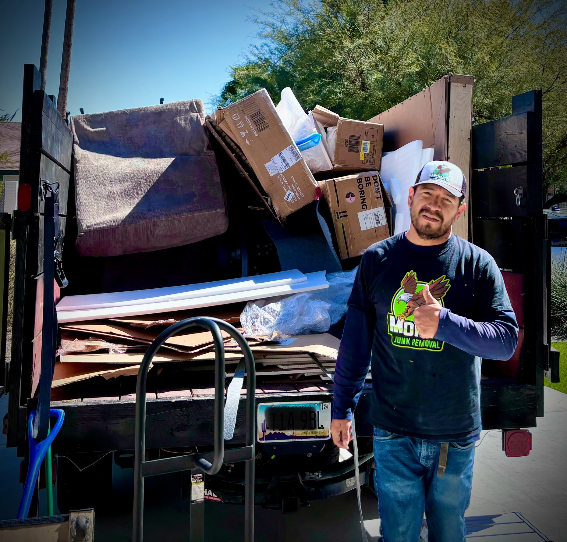 Mora's Junk Removal crew removing a grill in Scottsdale